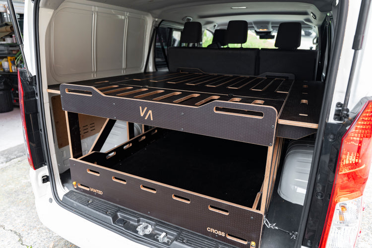 Close-up of Vanted plywood hexa surface — CNC-machined slatted bed panel detail, van conversion quality. Toyota Hiace van conversion kit with extendable sides.