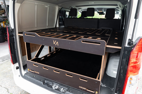 Close-up of Vanted plywood hexa surface — CNC-machined slatted bed panel detail, van conversion quality. Toyota Hiace van conversion kit with extendable sides. 
