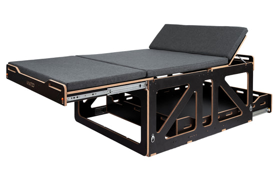 Vanted Cross slide-out bed — full extension showing slatted timber base and grey mattress, van conversion
